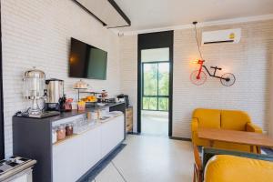 a kitchen with a bike hanging on the wall at Mosstel in Phitsanulok