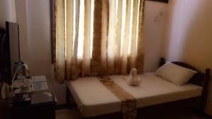 a small bedroom with a bed with a window at Dumdum Medical Plaza and Residences in Toledo City
