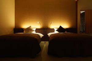Voodi või voodid majutusasutuse Kintarou Onsen Hotel toas
