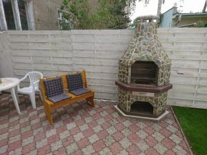 a outdoor oven and a chair on a patio at pokój blisko morza in Kołobrzeg
