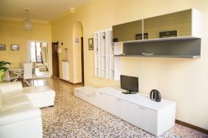 a living room with a couch and a tv on a wall at Ca' Geremia Apartment in Venice