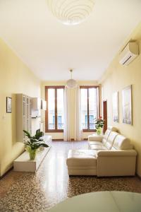 a living room with a white couch and some windows at Ca' Geremia Apartment in Venice