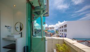 a bathroom with a sink and a view of the ocean at Reunion Residence in George Town