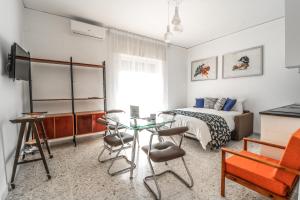 a bedroom with a bed and a table and chairs at Le stanze di Virgilio in Naples