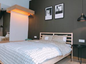 a bedroom with a bed and a wall with pictures at Mykey The Wave A-23-15 Melaka City in Melaka