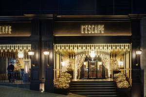 a store front at night with christmas lights at L'Escape Hotel in Seoul
