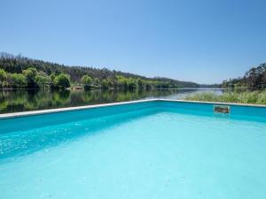 a swimming pool in the middle of a body of water at Traditional Mansion in Treixedo with Swimming Pool in Treixedo