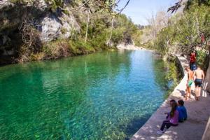 a group of people sitting on the edge of a river at Avenida de Daniel Gil 72 - 2º - 7ª in Ontinyent
