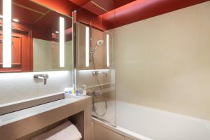 a bathroom with a shower and a sink at Hôtel le Derby Alma by Inwood Hotels in Paris