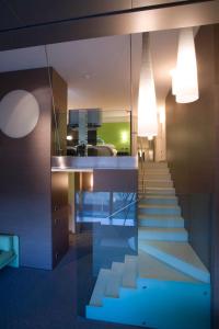 a room with a staircase leading up to the stairs at T Hotel in Cagliari