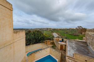 a view from the roof of a building with a swimming pool at Entire Villa - Gemini Farmhouse, Nadur Gozo in Nadur