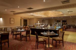 a restaurant with tables and chairs in a room at Bridgewood Manor Hotel & Spa in Chatham