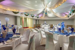 a banquet hall with white tables and white chairs at Bridgewood Manor Hotel & Spa in Chatham +37 photos