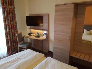 Postel nebo postele na pokoji v ubytování Hotel Merian Rothenburg