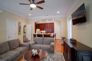 a living room with a couch and a ceiling fan at Beautiful 3Bed Townhome in Historic Downtown Savannah in Savannah