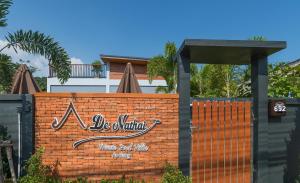 una recinzione di mattoni con un cartello sopra di De Nathai Private Pool Villa ad Aonang Beach
