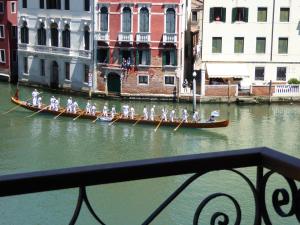 a group of people in boats in the water at B&b Vista sul Canal Grande in Venice