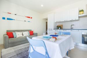 a kitchen and living room with a table and chairs at Blue Apartment IUN S0079 in Cala Gonone +37 photos