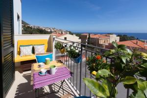 a balcony with a table and a view of the ocean at Blue Apartment IUN S0079 in Cala Gonone