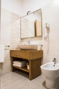 a bathroom with a toilet, sink and bathtub at Hotel Maria in Golfo Aranci