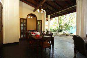 a dining room with a table and some chairs at Tree Breeze Inn in Kandy