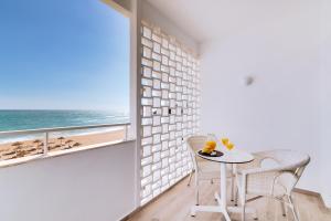 
a dining room table and chairs in front of the ocean at Hotel Sol e Mar Albufeira in Albufeira
