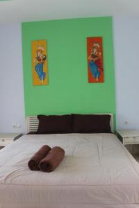 a bed with two towels on it in a bedroom at Paranyogan Homestay in Uluwatu +47 photos