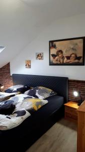 ヴィンターベルクにあるFerienwohnung Mittendrinのベッドルーム1室(黒いヘッドボード付きのベッド1台付)