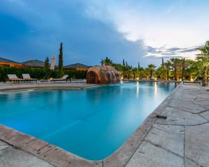 a large swimming pool with a water slide at Cresta Jwaneng in Jwaneng
