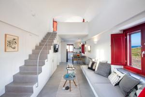 a living room with a staircase and a couch at Aplada Suites in Oia