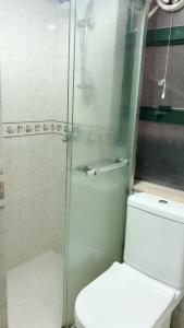 a bathroom with a toilet and a glass shower at Hung Fai Guest House in Hong Kong