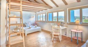 a small room with a bunk bed and a desk at ECO Aparthotel The Dreamers's Club in Lumbarda