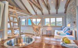 a kitchen and living room with a sink and a bunk bed at ECO Aparthotel The Dreamers's Club in Lumbarda
