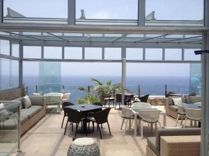 a restaurant with a view of the ocean at Bahia Blanca in Puerto Rico de Gran Canaria