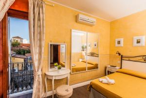 a hotel room with a bed and a balcony at Albergo Della Corte in Benevento