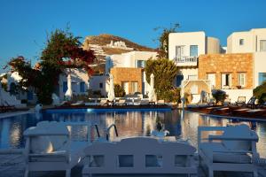 widok na basen z krzesłami i budynki w obiekcie Chora Resort Hotel & Spa w mieście Chora Folegandros