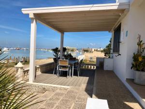 a patio with a table and chairs on a deck at Casa S Estany in La Savina