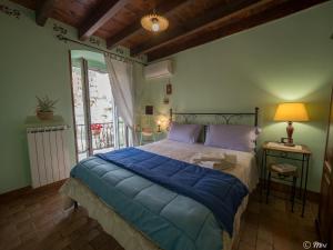 a bedroom with a large bed with a blue blanket at Affittacamere Le Terrazze in Corniglia