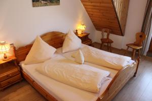 a hotel room with a bed and two nightstands at Landgasthof zum Schützen in Oberried