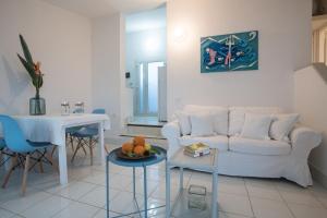 a living room with a white couch and a table at Sul Mare Sardegna Villa Anfitrite in Villasimius