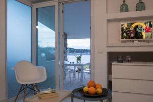 a living room with a view of the water and a table at Sul Mare Sardegna Villa Anfitrite in Villasimius