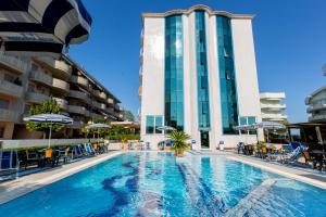 a swimming pool in front of a hotel at Hotel Ambassador in Tortoreto Lido