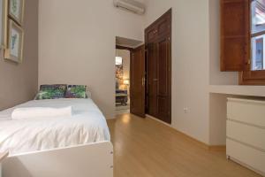 A bed or beds in a room at Abades Cathedral Oasis