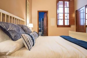 A bed or beds in a room at Abades Cathedral Oasis