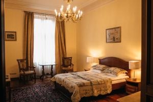 a hotel room with two beds and a lamp at British Club Lviv in Lviv