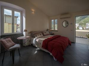 a bedroom with a large bed with a red blanket at Affittacamere Le Terrazze in Corniglia