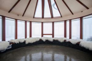 a room with snow covered seats in a room with windows at Klettar Tower Iceland in Fludir