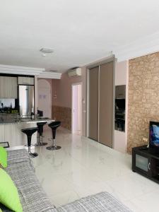 a living room with a couch and a kitchen at Orlando Apartment in Adeje