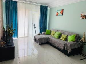 a living room with a couch with green pillows at Orlando Apartment in Adeje
