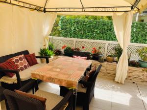 a patio with a table and chairs and an umbrella at Orlando Apartment in Adeje